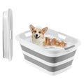 Collapsible pet bath tub with gray and white body, holding a small dog indoors