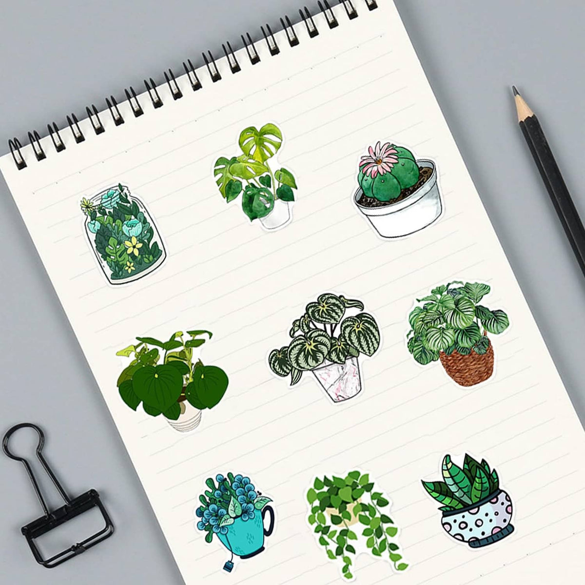 Green potted plant sticker set on a notebook page, multiple plant pot decals