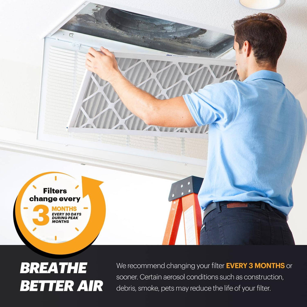 Installer holding MERV 11 air filter to a furnace return vent; breathable better air.