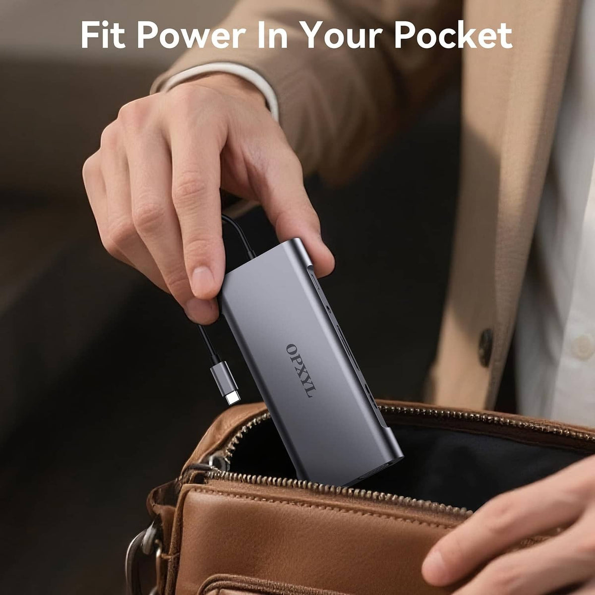 Grey USB-C hub held in hand with attached cable for on-the-go connectivity