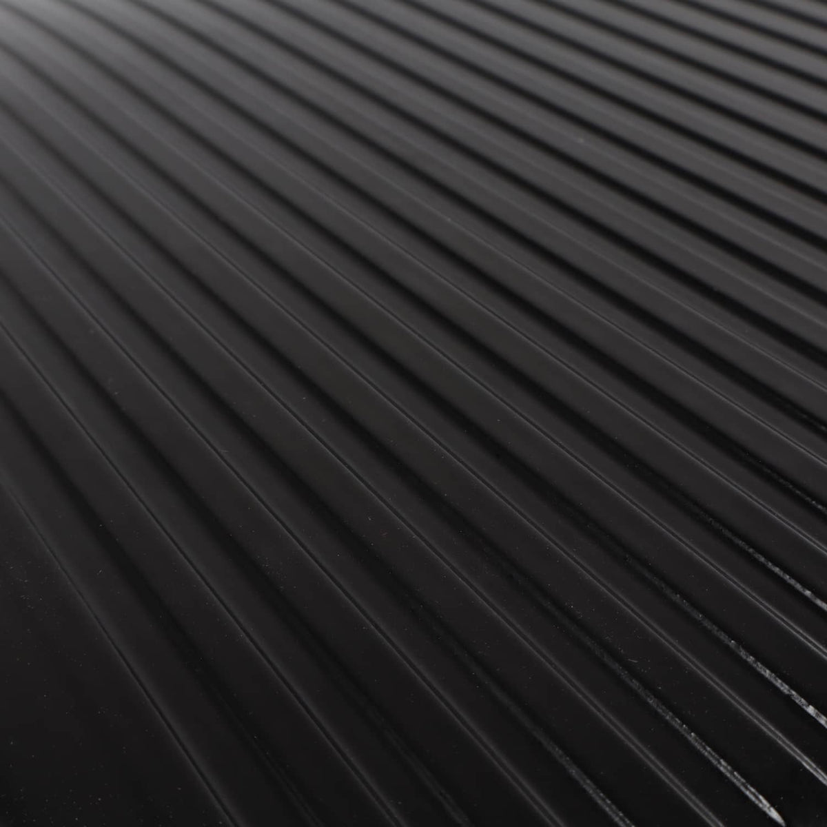 Close-up of black oil pan baffle ribs and cooling channels