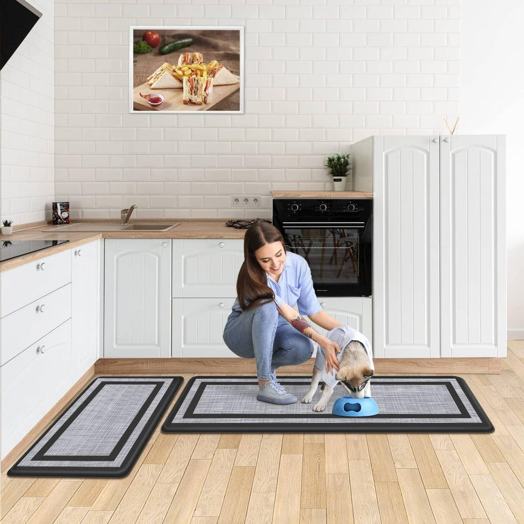 Kitchen floor mat set with black borders and light gray center under counter and pet