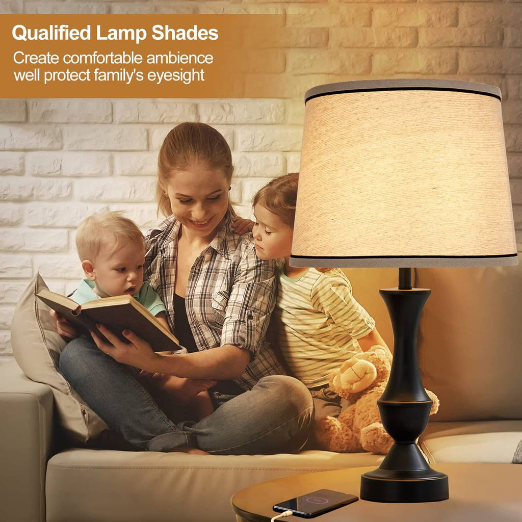 Beige fabric drum lamp shade with black trim on a table lamp
