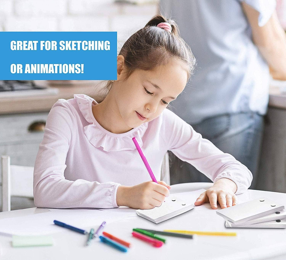Blank flip book paper sheets with holes, held open by a child sketching