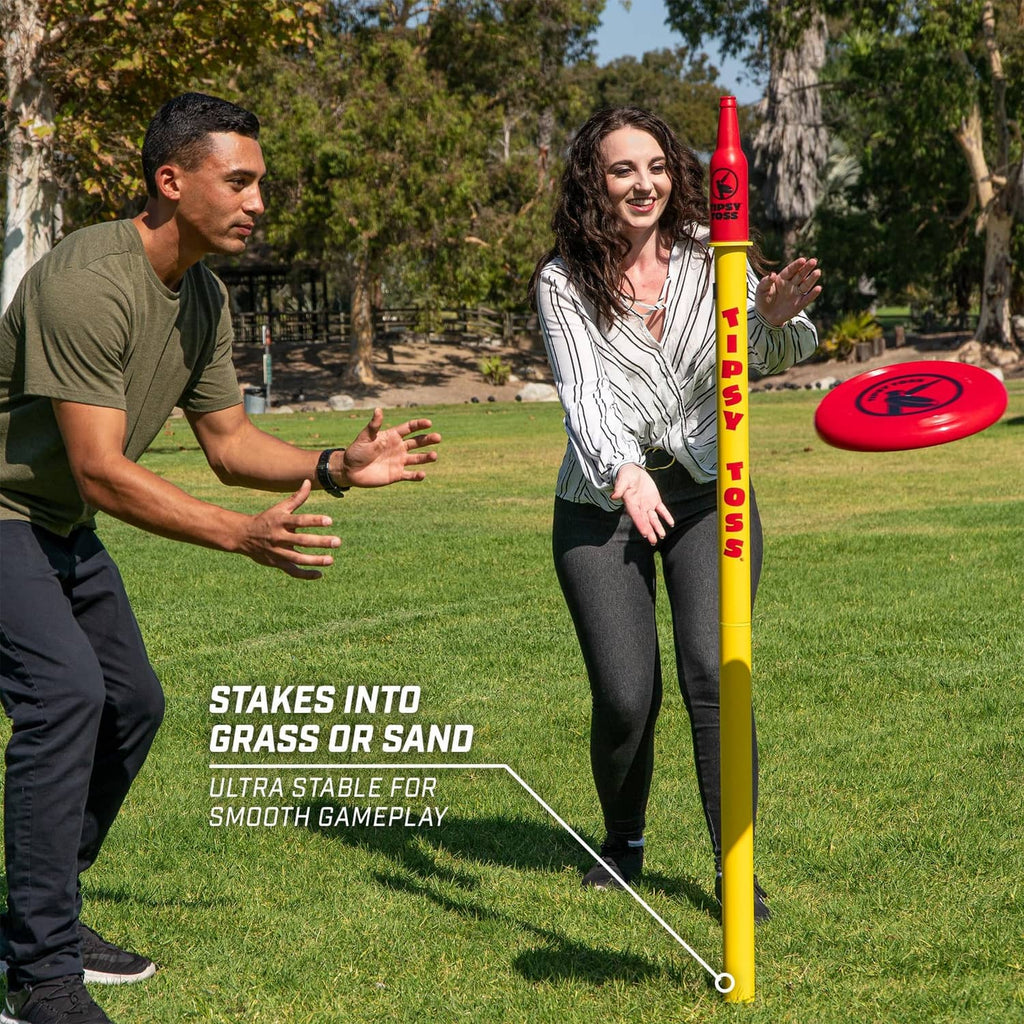 Tipsy Toss yard game with yellow score poles and red flying disc during play