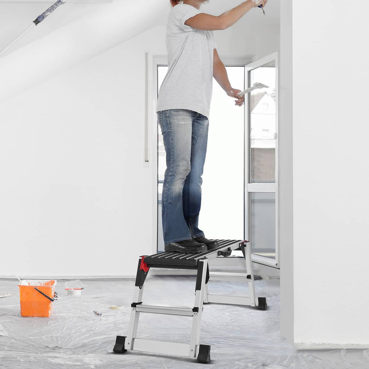 Aluminum folding work platform ladder with non-slip top and steps near an open doorway