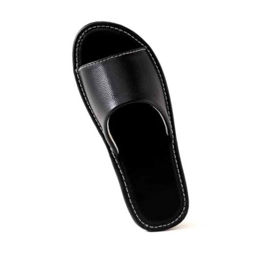 Black leather slide sandal with open toe and stitched strap, side view.