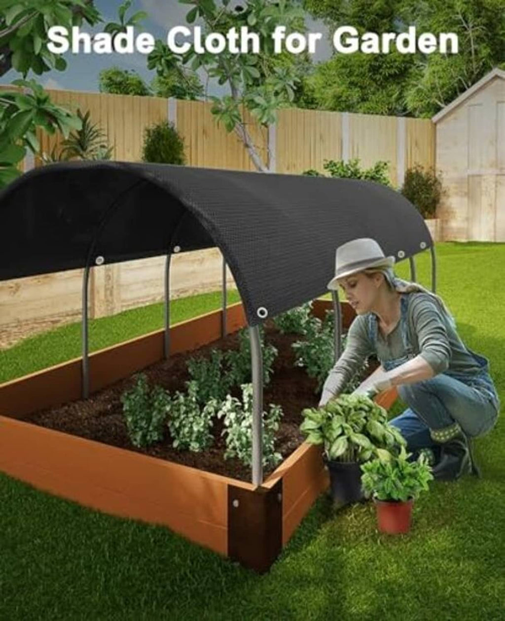 Black shade cloth canopy over a raised garden bed, secured with metal corner grommets