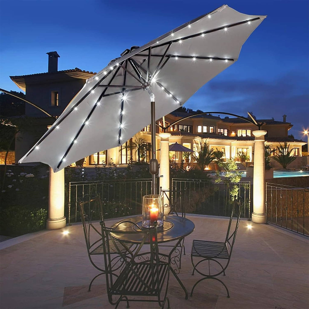 Gray lit patio umbrella with LED string lights and tilted open canopy