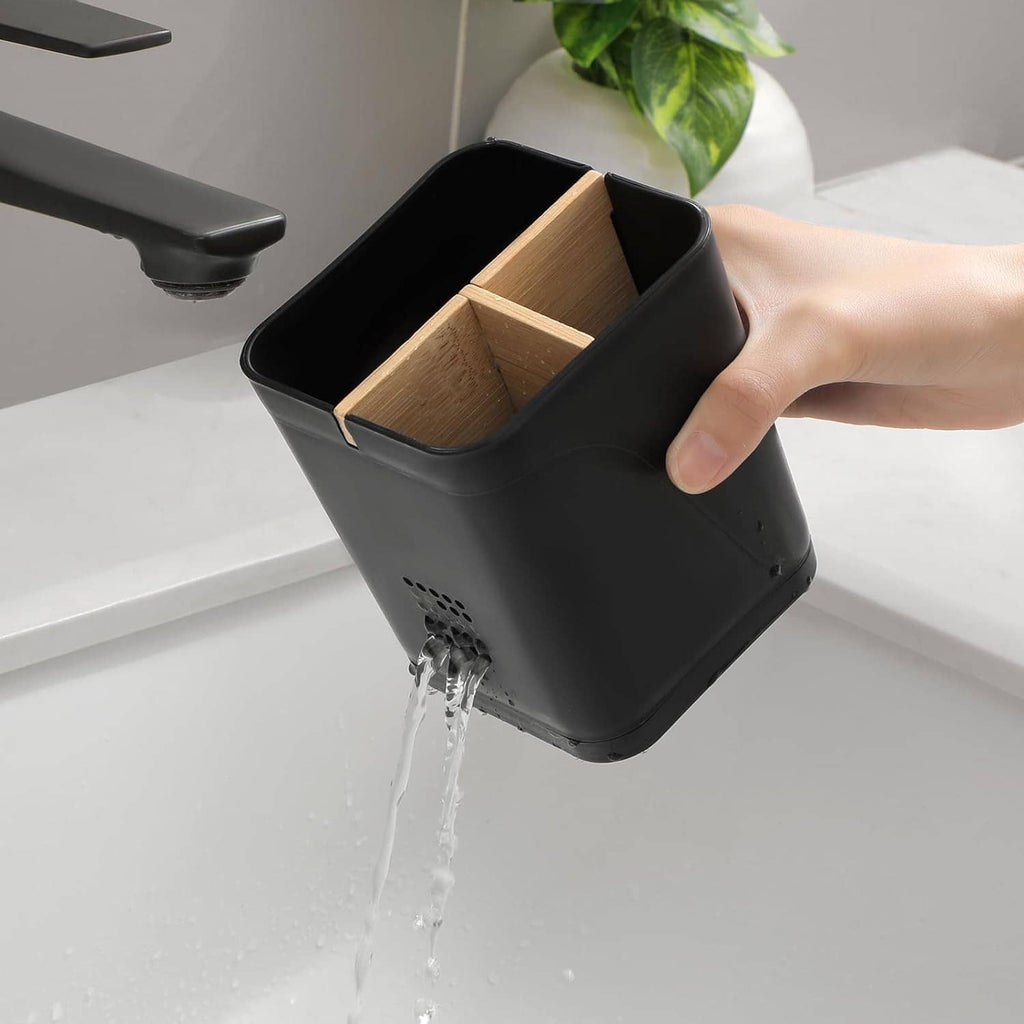 Black toothbrush holder with removable divider, hand holding inner compartments