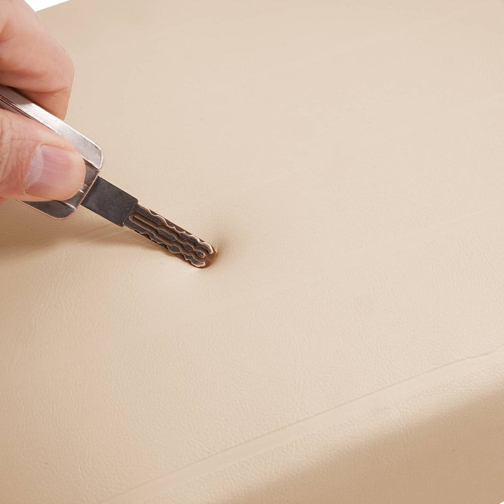 Beige cushion panel with edge stitching where a hand tool is applied