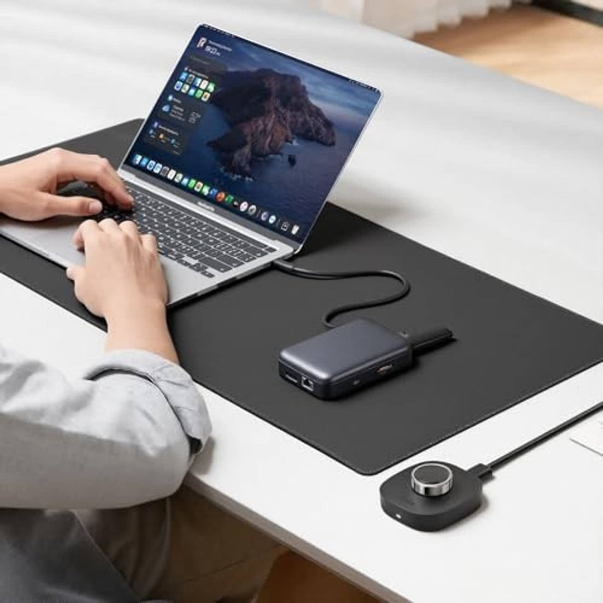 Black smart ring charger dock on desk with USB-A cable connected