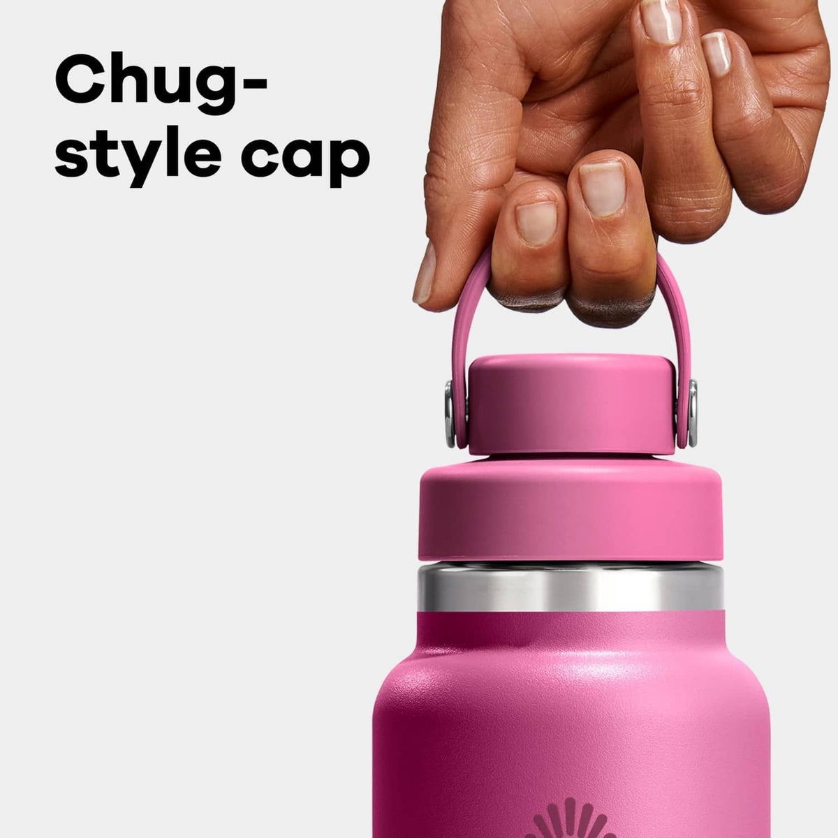 Insulated stainless steel water bottle with magenta cap and carry handle, held by hand.