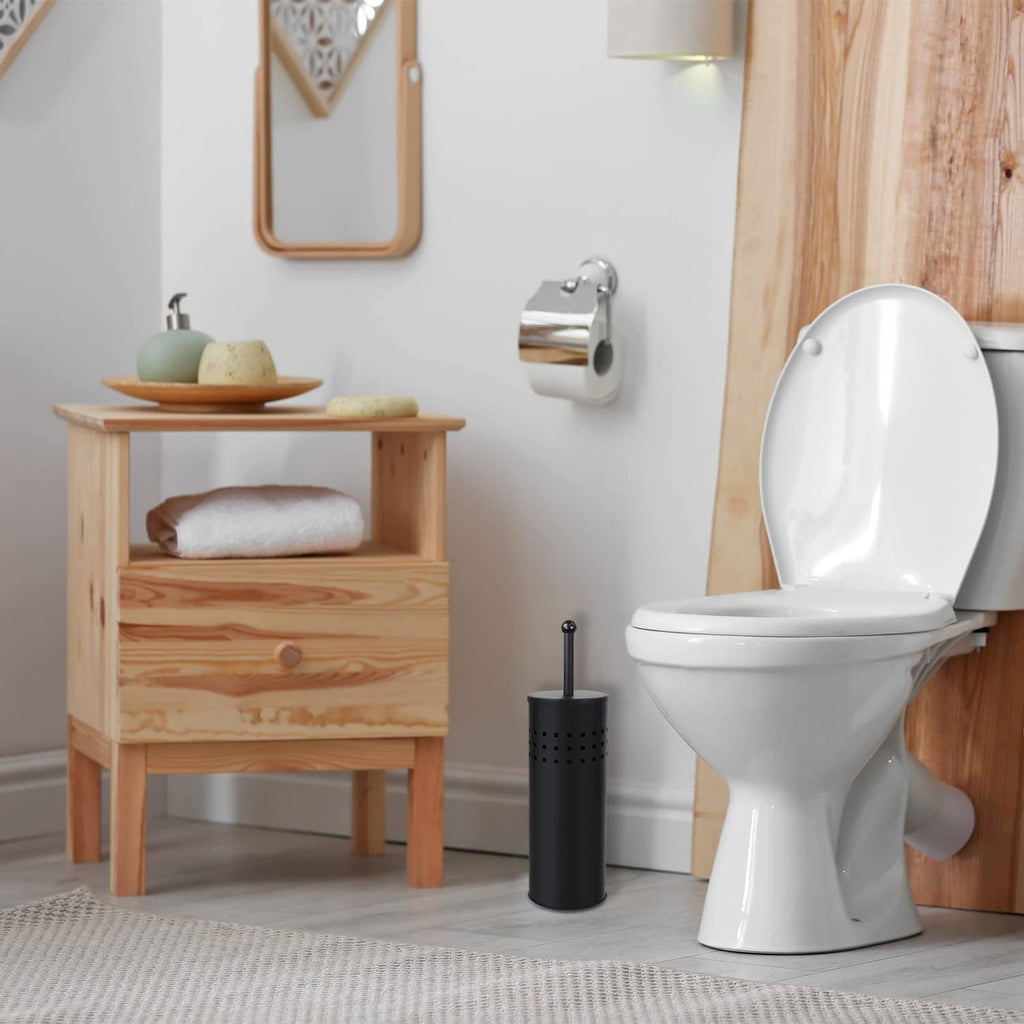 Black toilet plunger in a perforated holder beside a white toilet