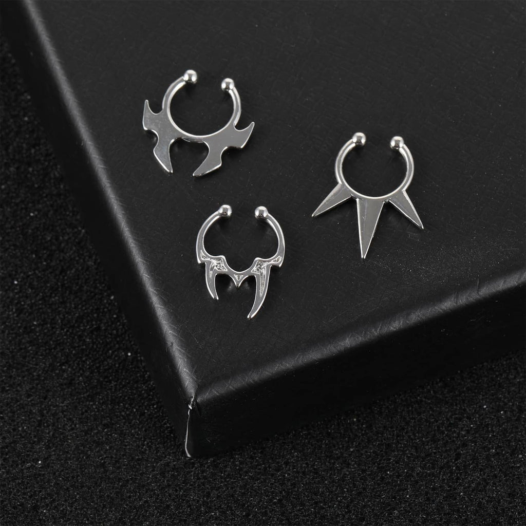Silver faux septum rings, three spiked hoop styles shown on black surface