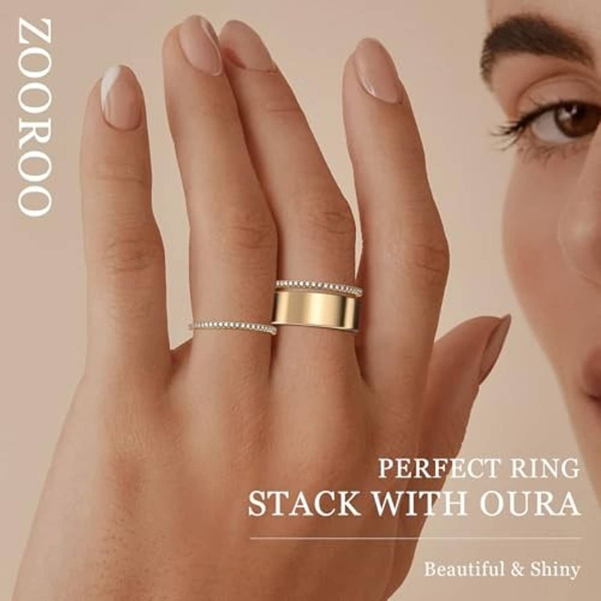 Gold Oura Ring stackable bands, one thin pavé band and one wide polished band on a hand