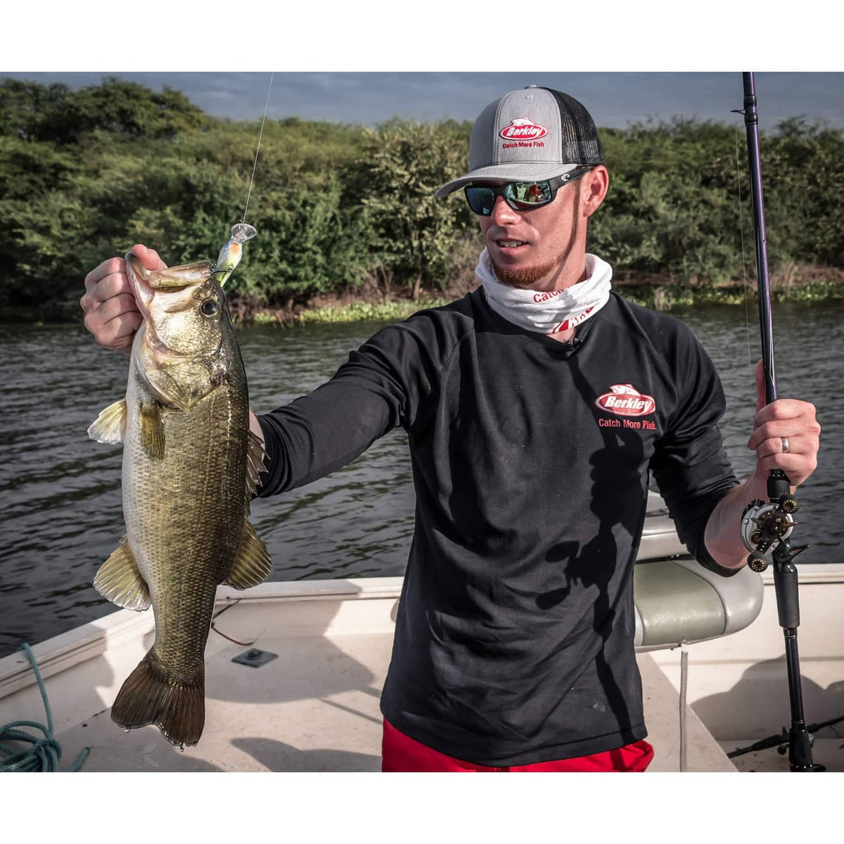 Angler holding a large bass while using clear monofilament fishing line