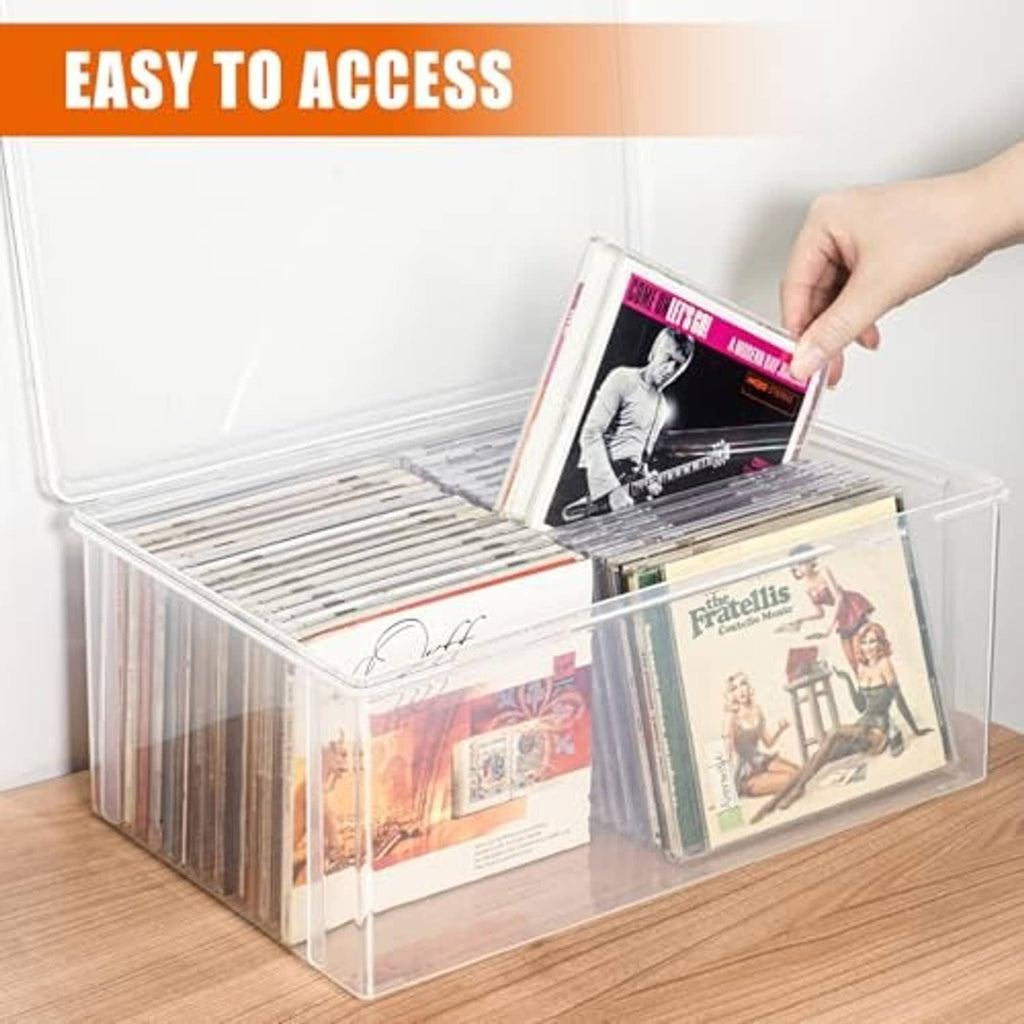 Clear CD storage box with lid open; hand placing a CD into the compartment