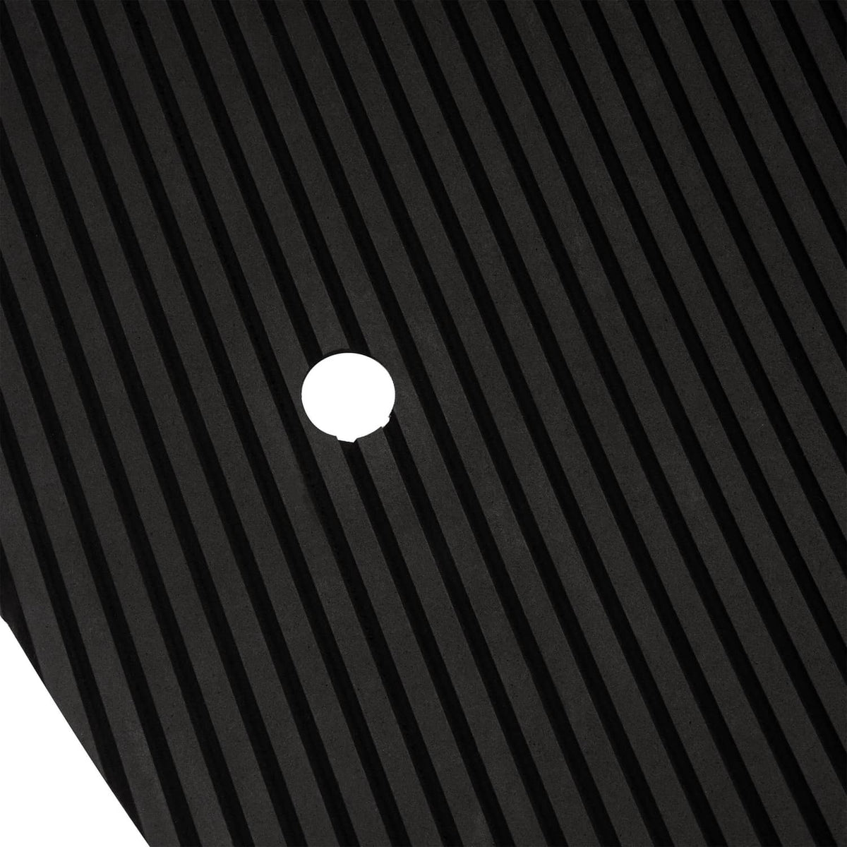 Black textured traction mat insert close-up, ridged pattern with round fastener dot