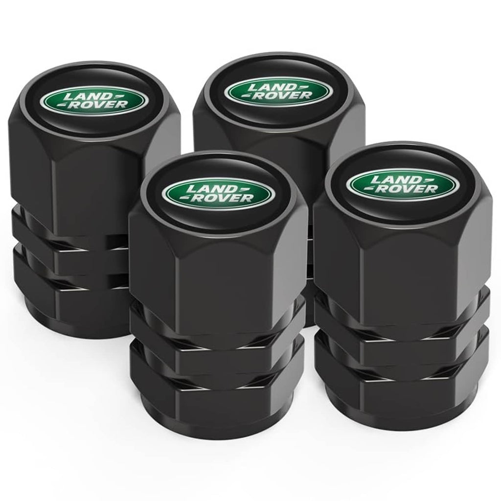Four black metal tire valve stem caps, each with green Land Rover logo