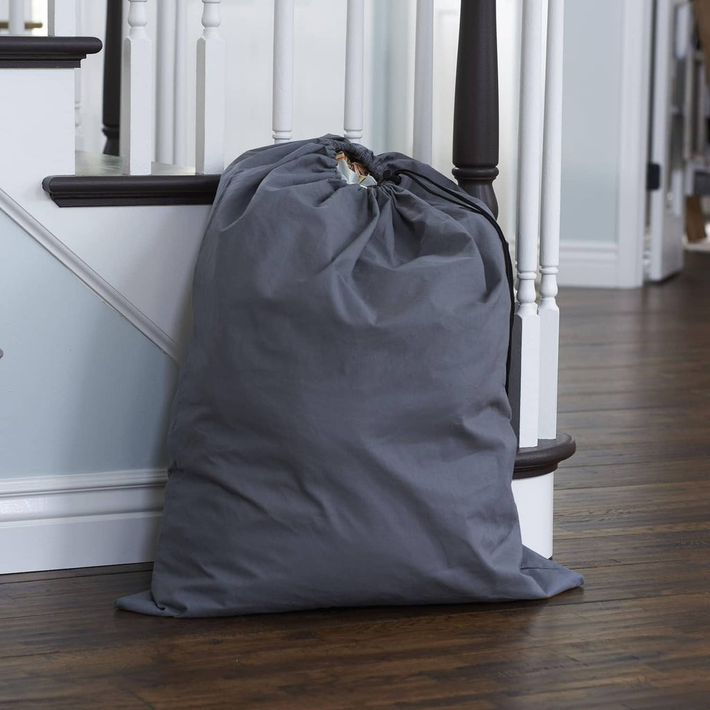 Grey cotton drawstring storage bag standing, cinched with black cord