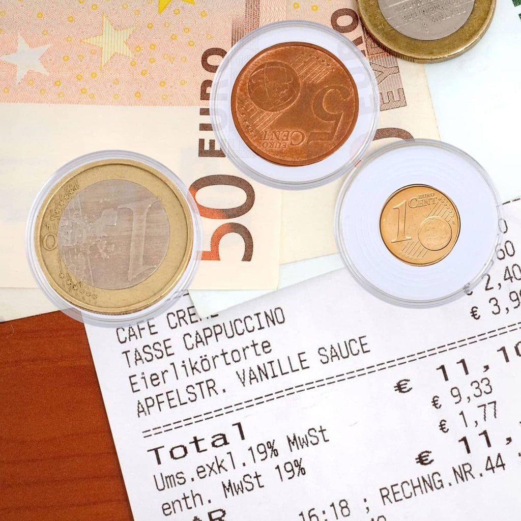 Clear plastic coin capsule holding a coin on top of a currency banknote