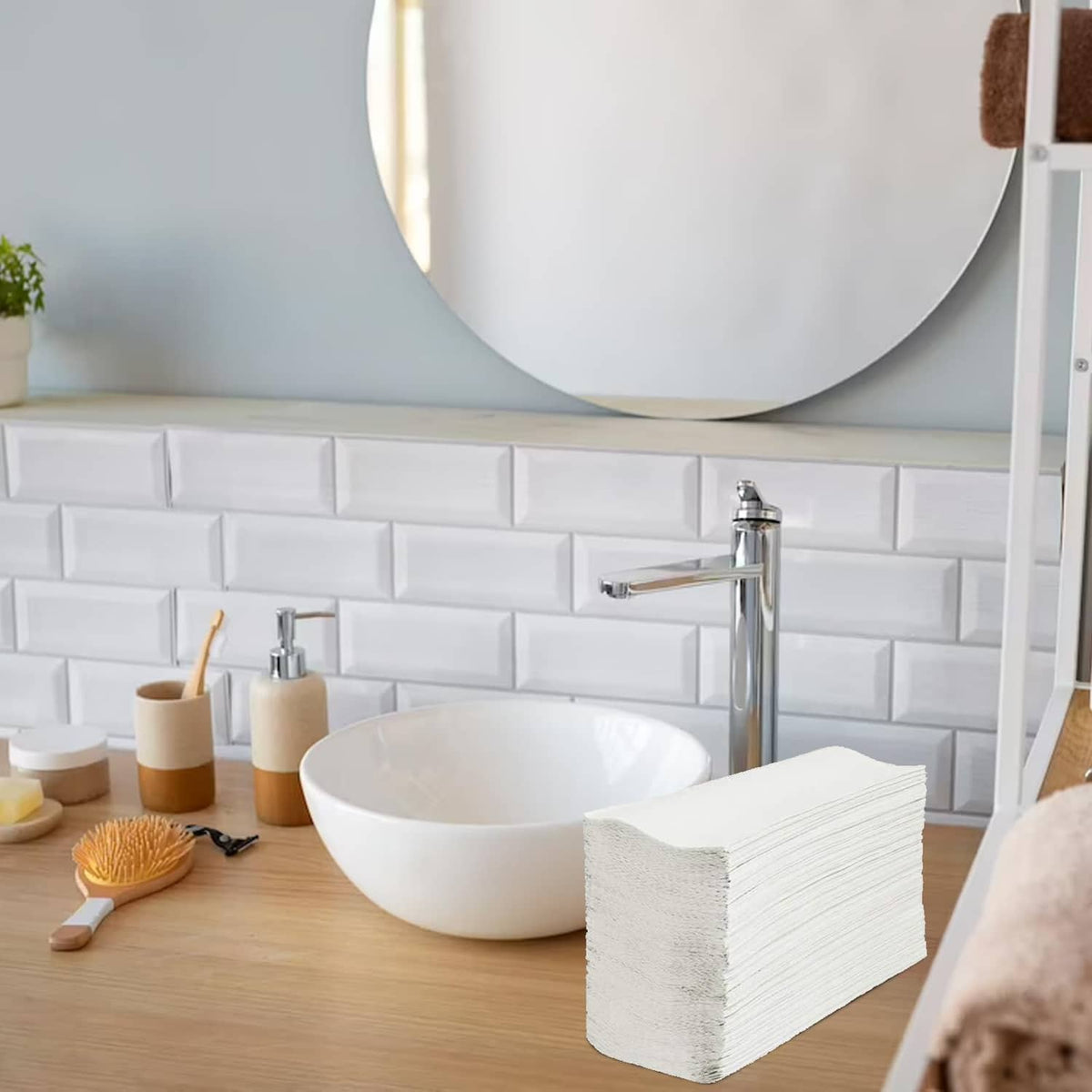 Stack of white multi-fold paper towels on bathroom vanity near sink