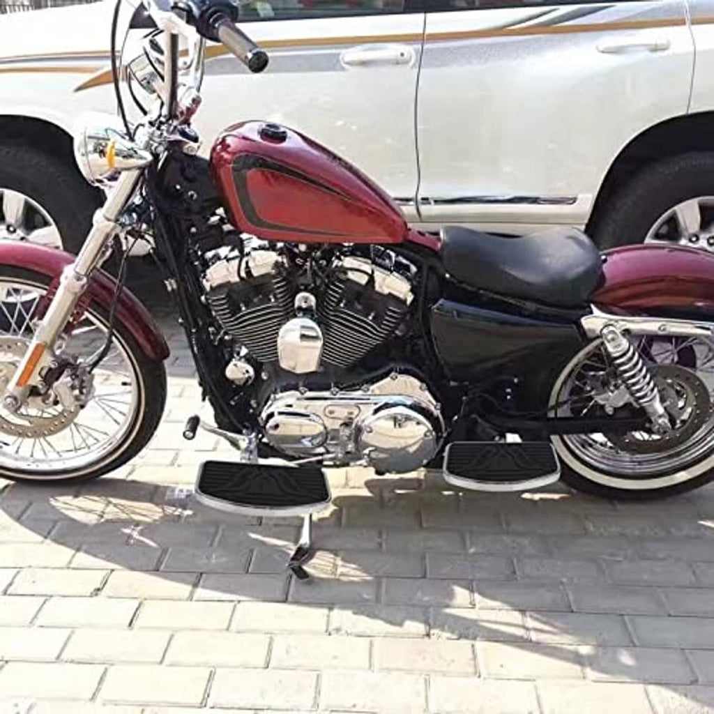 Motorcycle floorboard foot pegs mounted on bike with black tread and chrome edges
