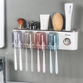 Bathroom toothbrush holder with four clear color cups and hanging toothbrushes
