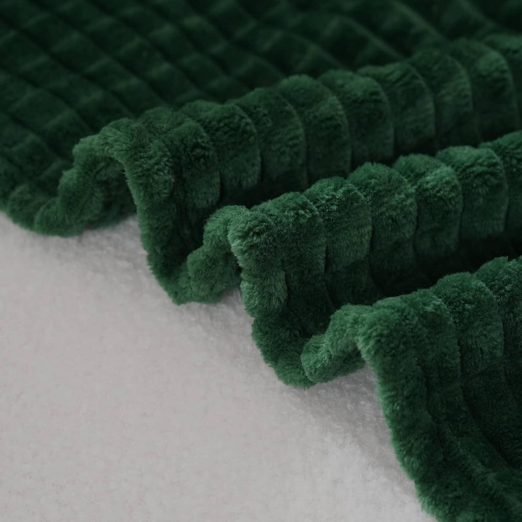 Dark green flannel fleece throw blanket edge close-up, thick plush rows texture