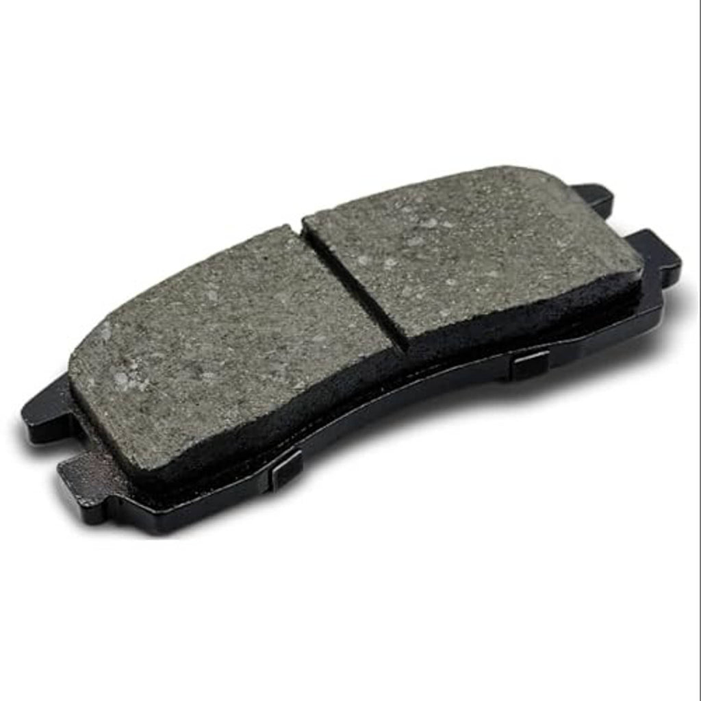 Single gray ceramic brake pad with metal backing and tabs, angled front view