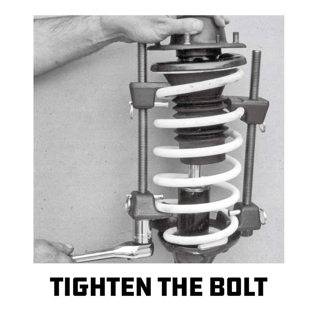 Strut spring compressor kit installed on coil spring with two threaded rods and bolts