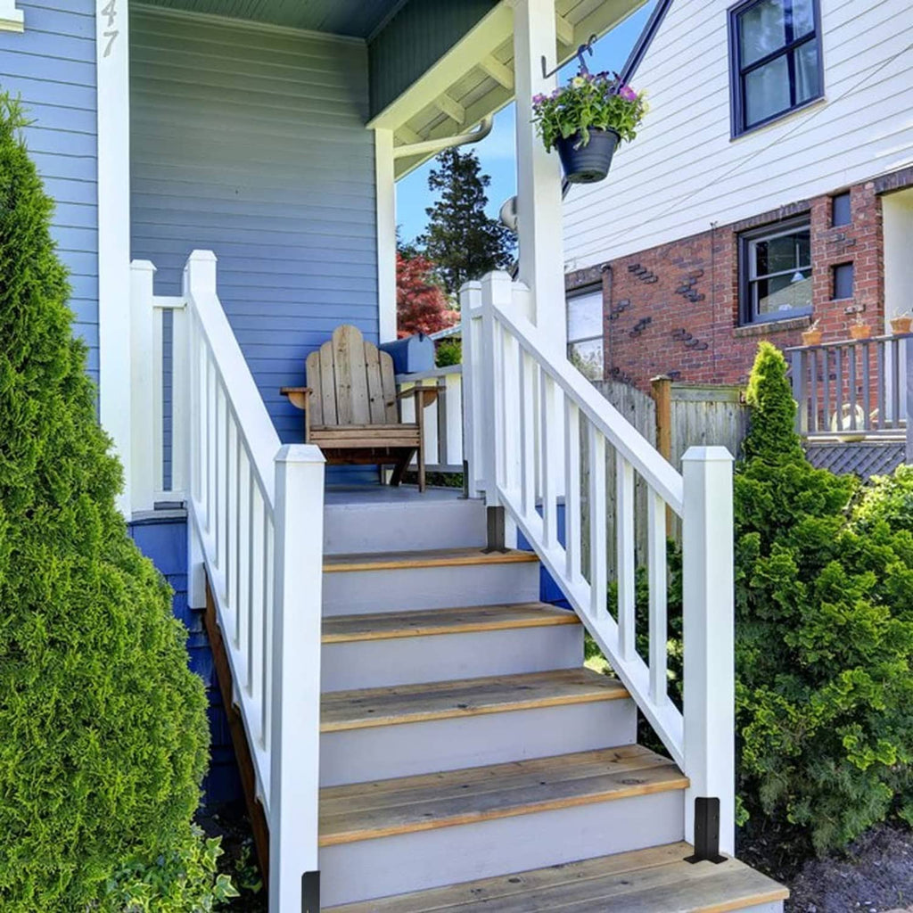 Black metal base plates under porch railing posts on wooden steps