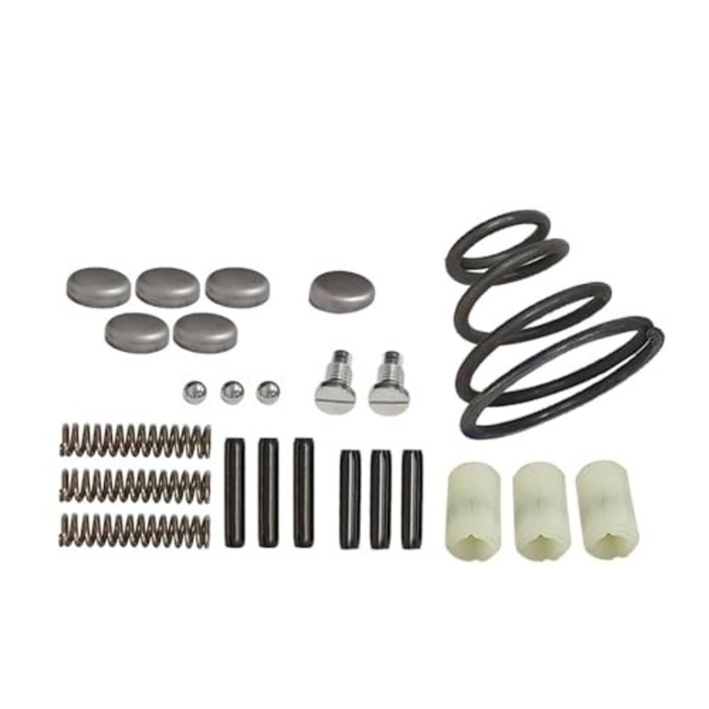 Transmission shifter rebuild set laid out: caps, pins, springs, and white bushings