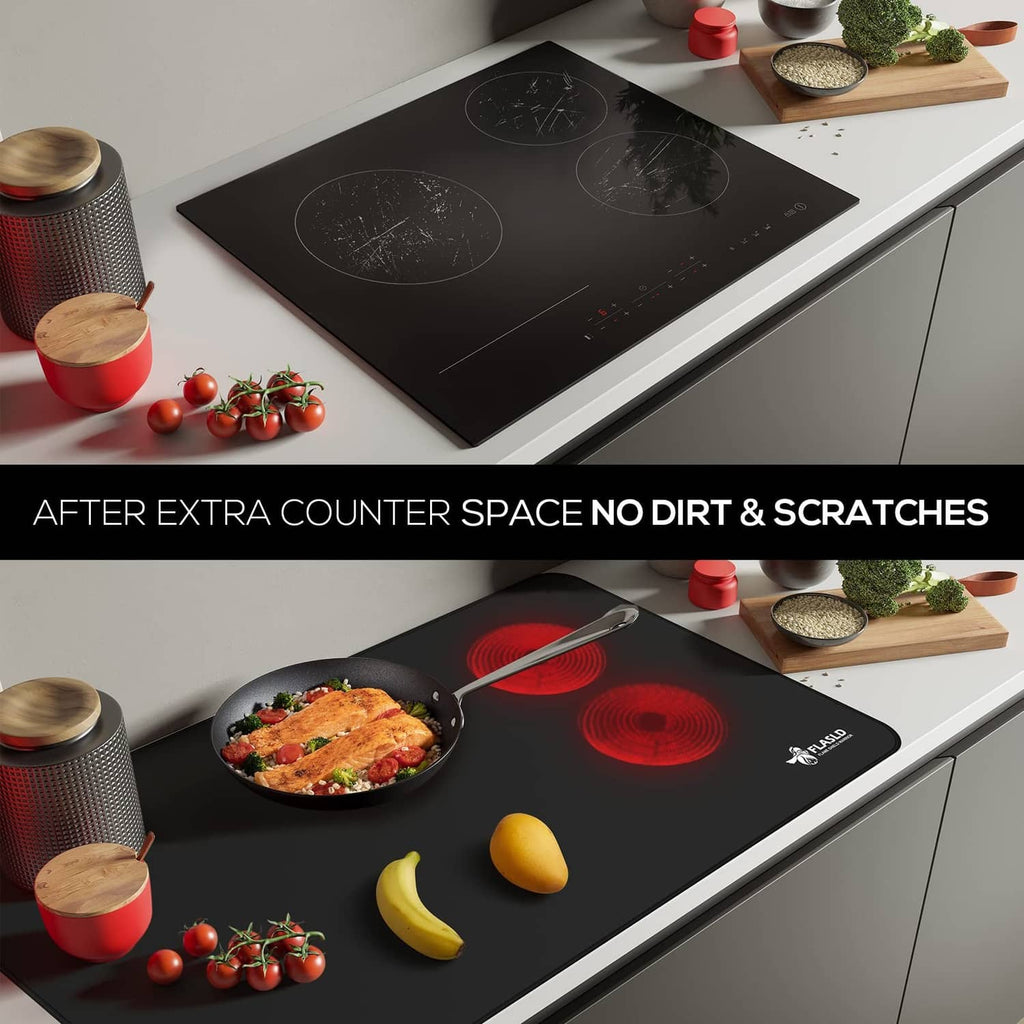 Black stove top cover placed on an electric cooktop for spill protection