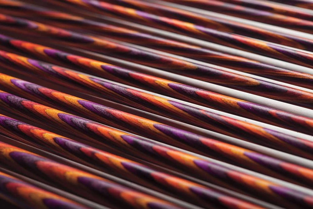Close-up view of multicolor mosaic wood knitting needle shafts