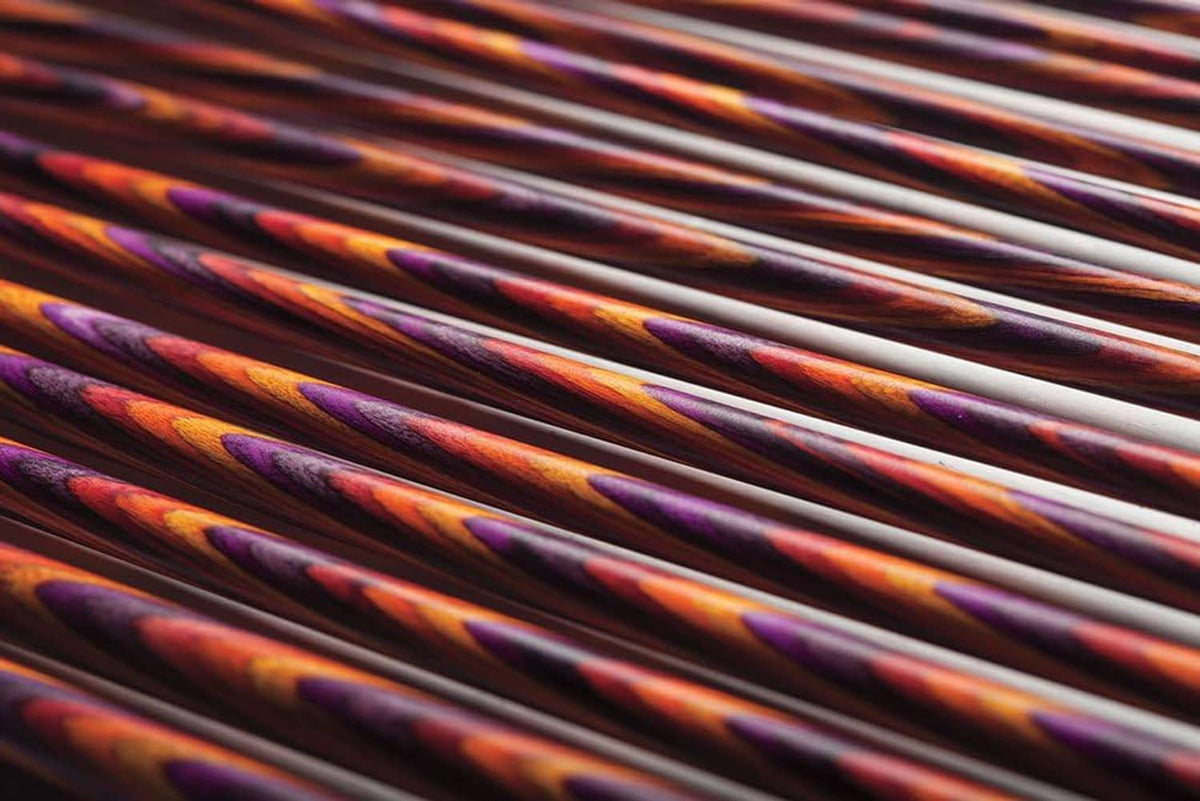 Close-up view of multicolor mosaic wood knitting needle shafts