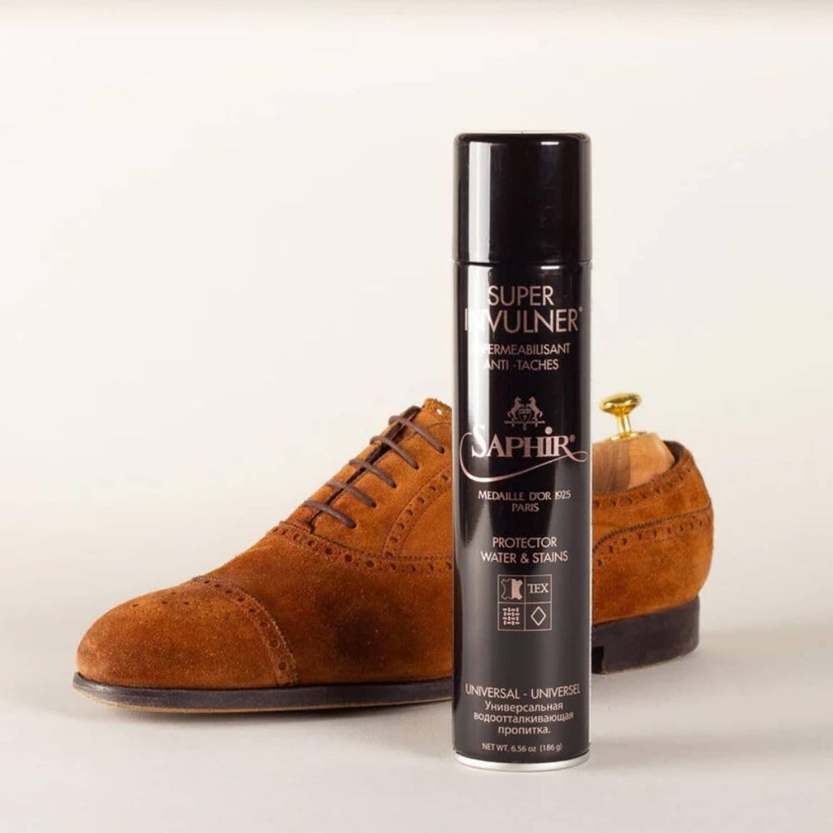 SAPHIR waterproof spray can next to brown suede lace-up boots
