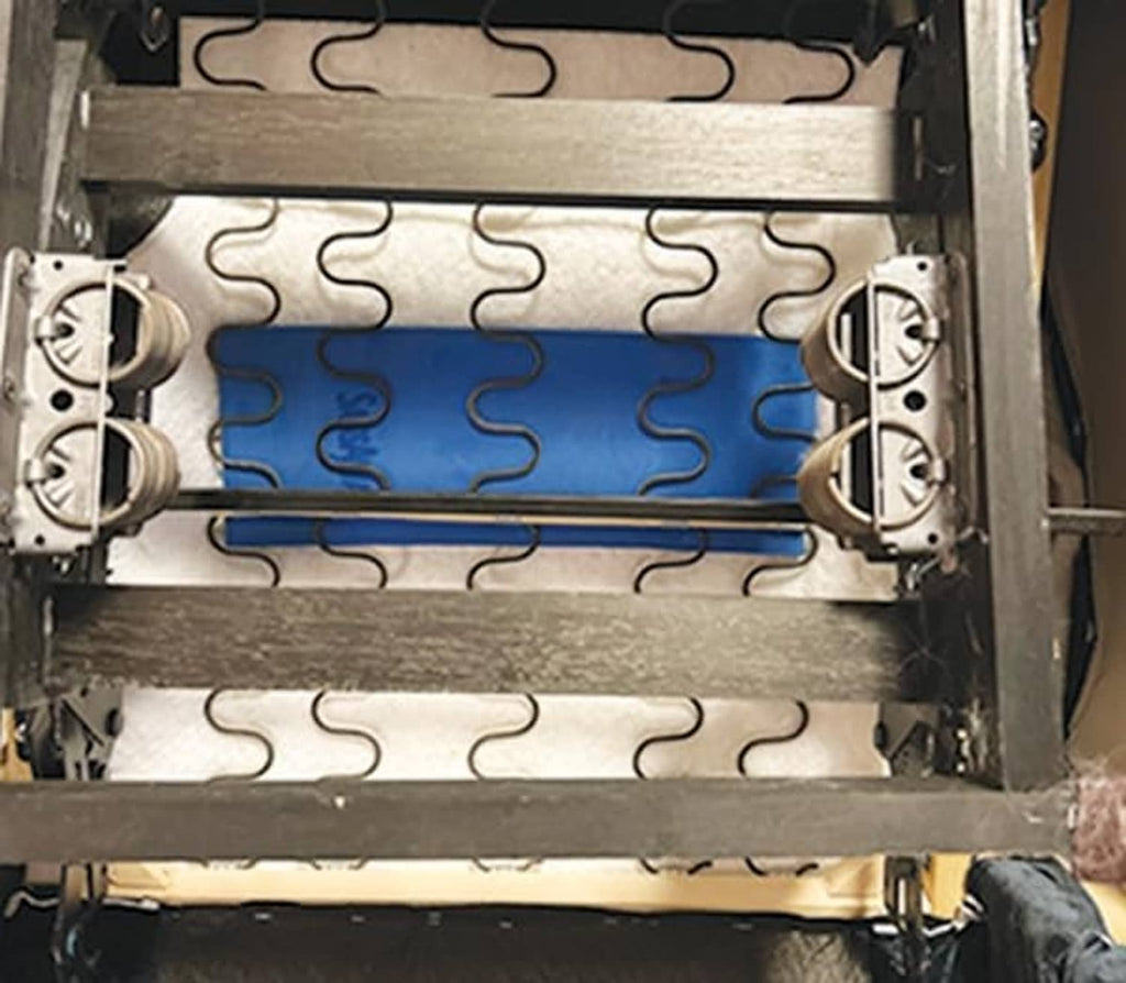 Installed view of blue recliner repair pads within spring insert frame