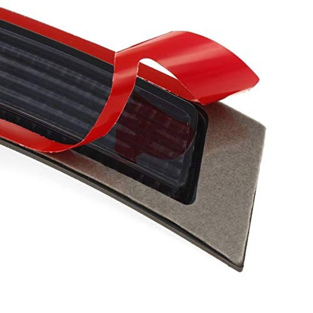 Close-up of smoked fender bumper reflector with red trim and black textured lens