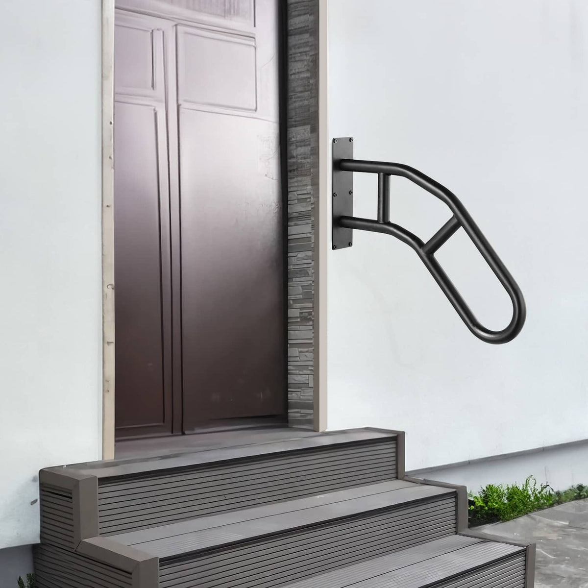 Black wall-mounted handrail next to steps with curved non-slip grip