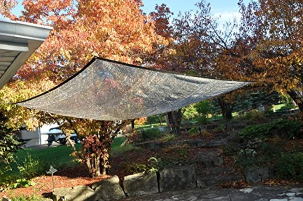 Sun shade sail with grey mesh and black-trimmed corners outdoors