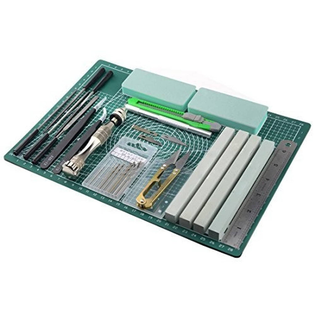 Model tools kit with green cutting mat, blades, clamps, and straight-edge rulers