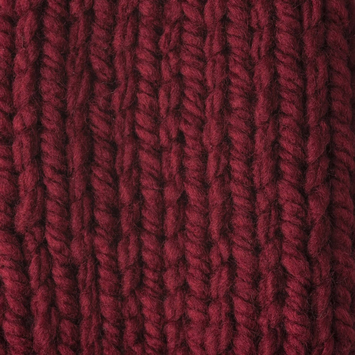 Close-up of maroon chunky yarn strands with vertical ribbed texture