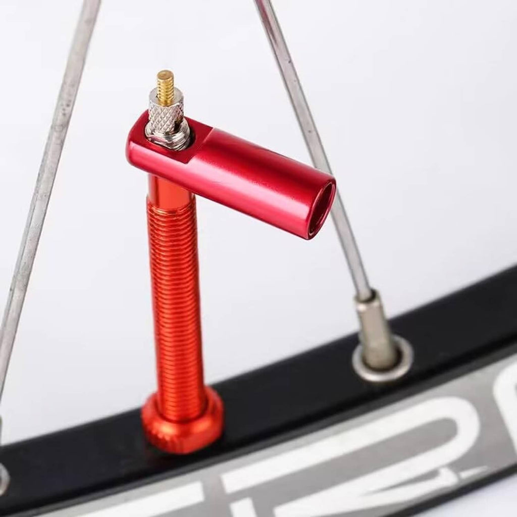 Red Presta valve stem cap on rim with silver valve insert