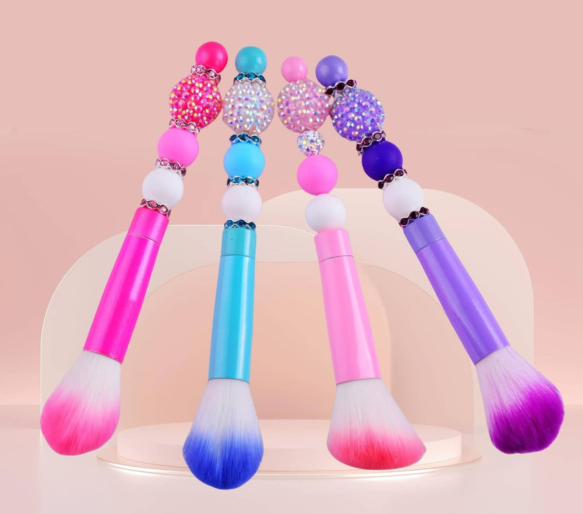Rhinestone-beaded brush handles with faceted round bead tops in pink, blue, and purple