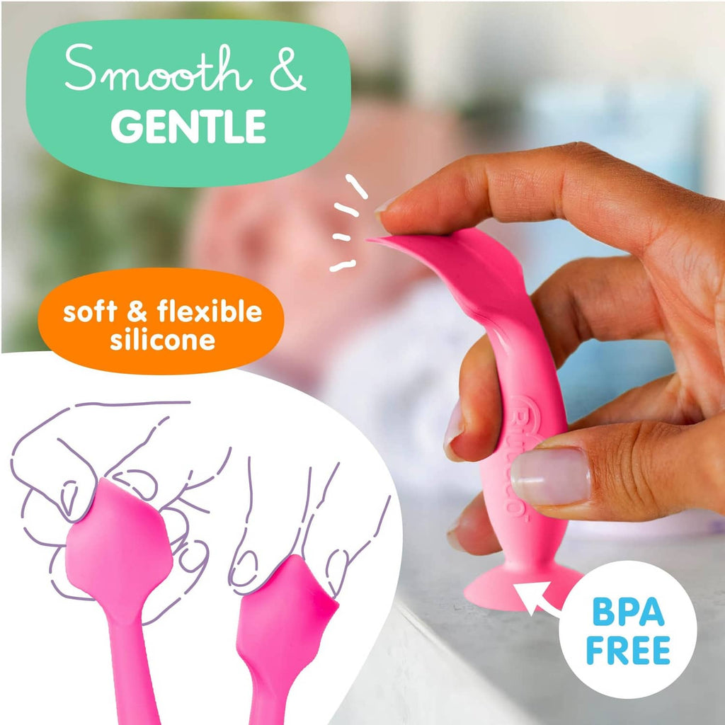 Pink baby bum brush with soft flexible silicone head held in hand