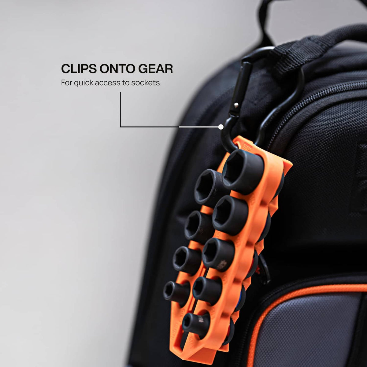 Socket set organizer with orange clips attached to a black carry bag