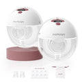 Double wearable breast pump set with two white pump cups, Cozy Red accents, and accessories