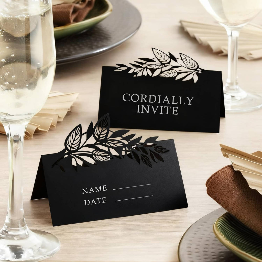 Black invitation cards with white floral design and "Cordially Invite" text.